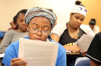 Cailah Porter, 15, reads over an example of a short story.