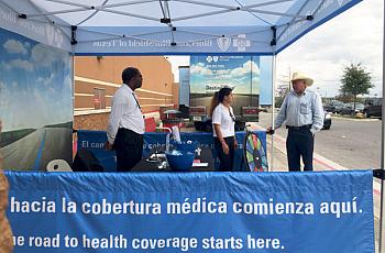 Insurance agents working with Blue Cross Blue Shield of Texas answered questions outside of a Target in San Antonio. (Veronica Zaragovia/KUT)