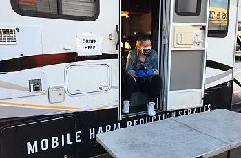 Michaella Jones hands out sterile supplies from the HEPPAC mobile outreach vehicle in April 2020.