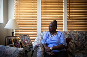 Anita Fisher looks toward a photo of her son at her home in Spring Valley, Aug. 16, 2022.