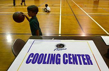 Kids play basketball at Ted C. Wills Center, on 770 N San Pablo Ave, Fresno which is one the four cooling centers in the city of