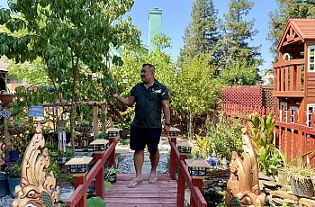 Danny Kim walking in his backyard garden on Sept. 15 in Fresno, Calif.