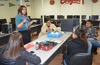 Karolynn Tom, who works with Jessica Black at Heritage University, is teaching students how to set up air quality monitors.