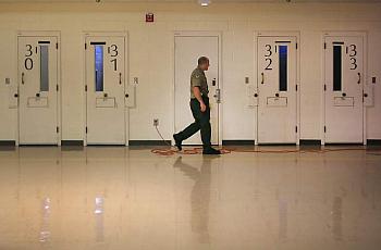 A Sonoma County sheriff corrections officer makes his rounds in the mental health wing at the Sonoma County Main Adult Detention