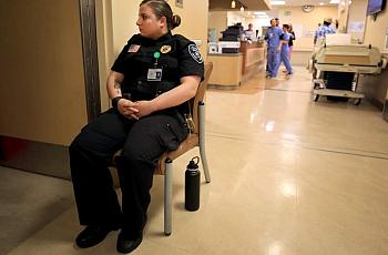 Hazel Brownfield Rosalie of Allied Universal Security keeps watch on a mental health patient in the emergency room. 