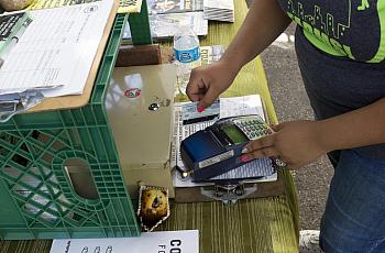 A customer swipes an EBT card at a farmers' market in New York City. Andrew Lichtenstein / Corbis via Getty Images file