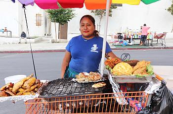 Carolina stands behind a homemade food cart at the Guatemalan Night Market in the Westlake neighborhood of Los Angeles.