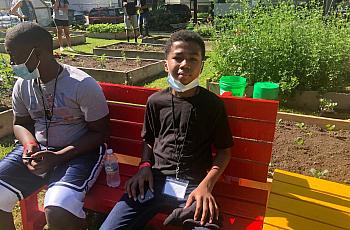Izaiah Cole, 14, takes a break after cleaning up several blocks near the We Got This urban garden with columnist James E. Causey
