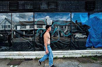 Travis Litts walks past an abandoned business along East Ridge Street in Lansford. He is one of Pennsylvania's many rural reside