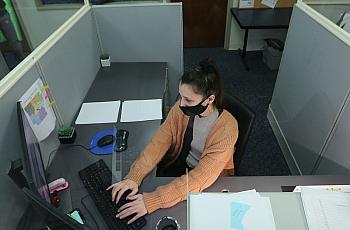 Brittany Irby, a state child abuse hotline operator, works on abuse reports at her workstation 