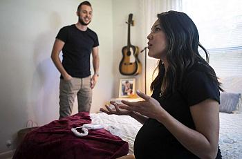 Marissa Mayberry, 28, talks as she sits on her bed and her husband Matthew, 28, listens at their home in Hondo, Texas on May 19,