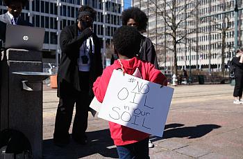 A young boy wears a sign outside of City Hall, protesting the construction of the Byhalia Connection Pipeline, Tuesday, Feb 23