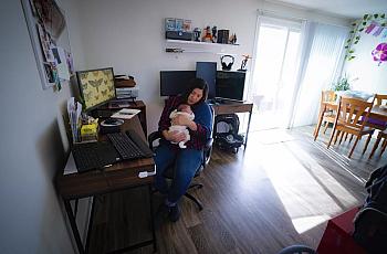 Zaira Reynoso juggles caring for her 2-week-old baby, Ander, and checking email at her home in Chula Vista.