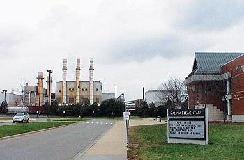 A fence separates Salina Elementary School in Dearborn's southend from industrial sources, including the former Severstal plant that is pictured here right across from the school. (Photo by Arab American News)