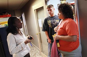 A social worker talks with a mother about signing up her son for food steps in Fort Lauderdale, Florida.