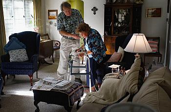 Nurse Stephen Van Dyke helps Mary Donahue, 100, with her exercises in her Denver home. A local nonprofit provides free home nurs