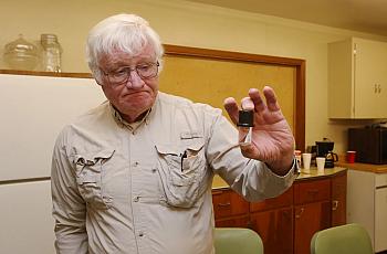 Mike Matthews holds a vial he uses when testing for nitrate in water on December 1. Each test costs $16. There are 37 reverse os