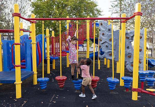 Ruthie, 7, left, and Justice, 6, play on the equipment at Soraparu Playspot 