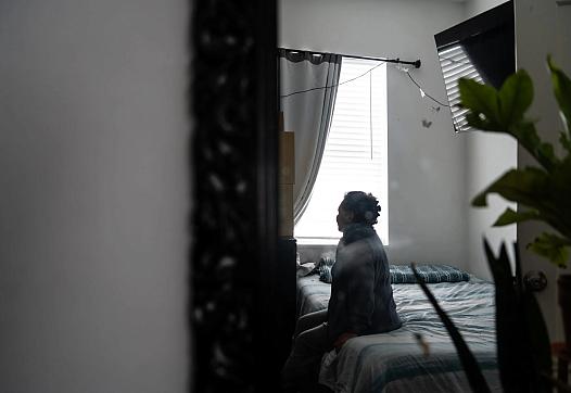 Woman sitting on bed