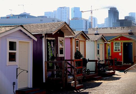 multiple small houses of different colors in a row