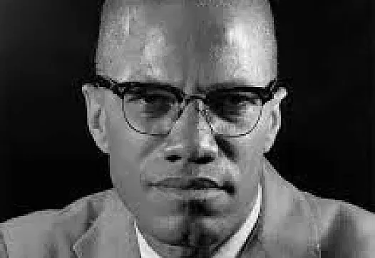 Non-colored picture depicting a person in a suit and glasses with a tie