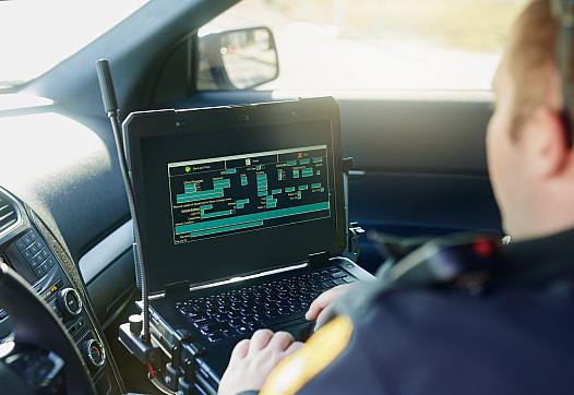 Police working on their laptop in the car