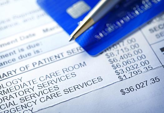 Medical Bills with credit card and pen