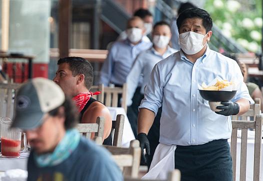 Waiter at a restaurant wearing a mask