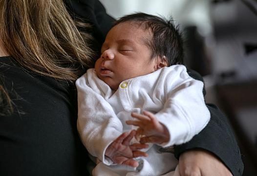 Baby in someone's arms