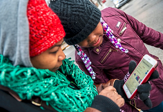 A person and a child looking at a phone