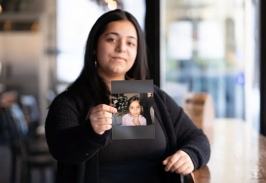 Person holding a photograph