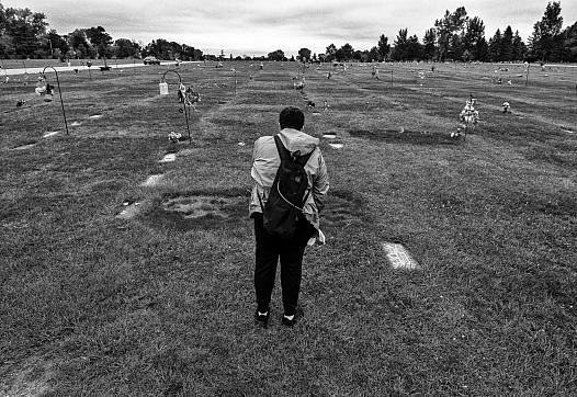 Black and white picture of a person in a graveyard