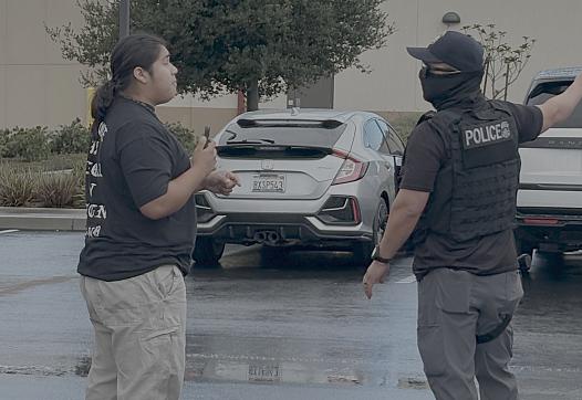 A person confronts an ICE officer 