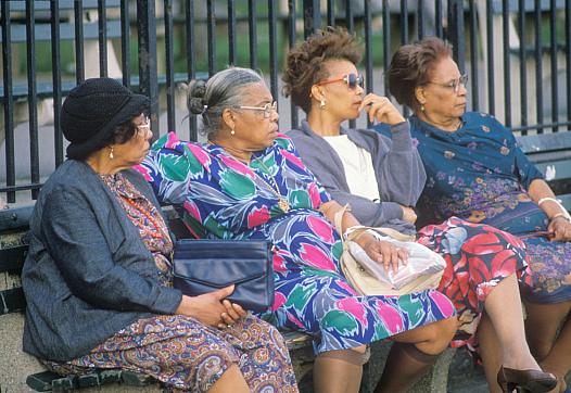 Four women on a park bench