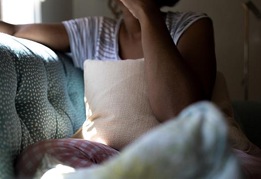 A person sits on a couch.