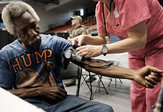 Healthcare worker checking blood pressure of a person