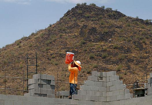 A worker standing betwen bricks 