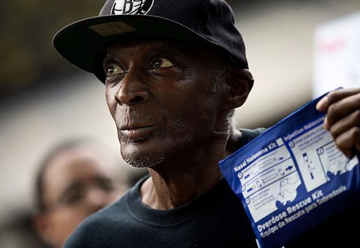 A man holding an overdose rescue kit