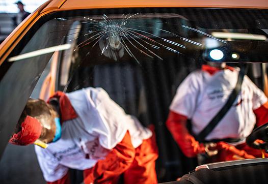 crash test dummies in a car with broken wind shield