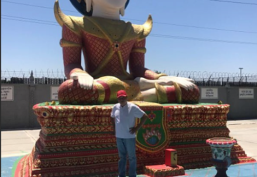 Person standing in front of a large statue