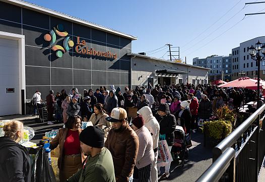 People waiting in line to pick up food 