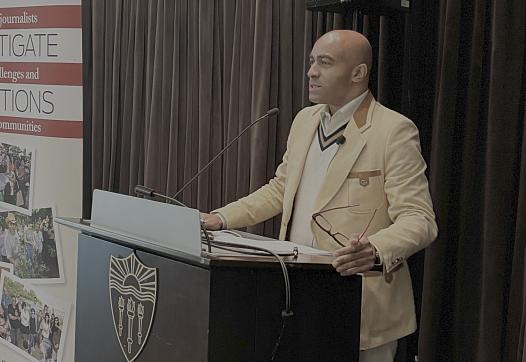 Lee Hawkins speaks at a podium.