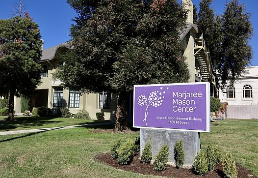 Purple sign surrounded by grass