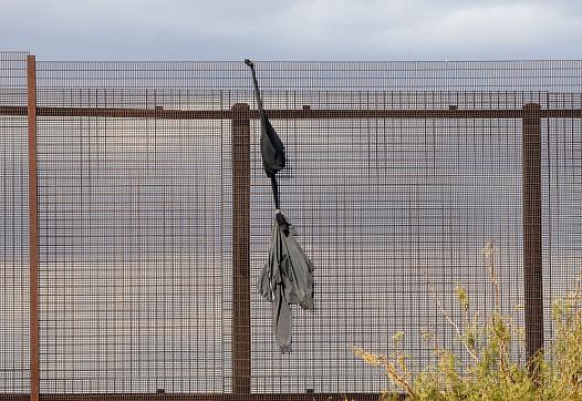 A sweatshirt dangles the border wall between Ciudad Juarez, Mexico, and El Paso, United States. 