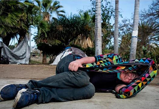 A person sleeping on sidewalk