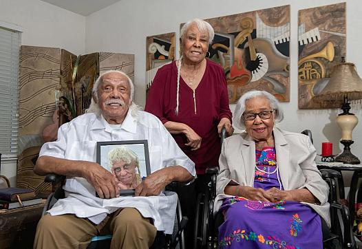 Three people, two seated