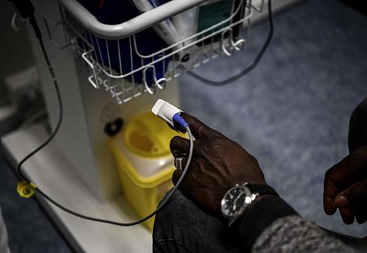 A patient using a pulseoximeter in the hospital