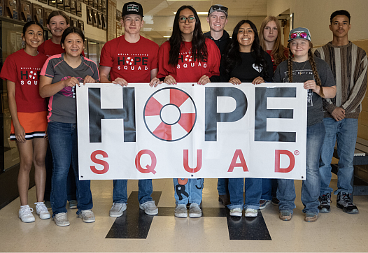 Group of people holding a 'Hope Squad' sign