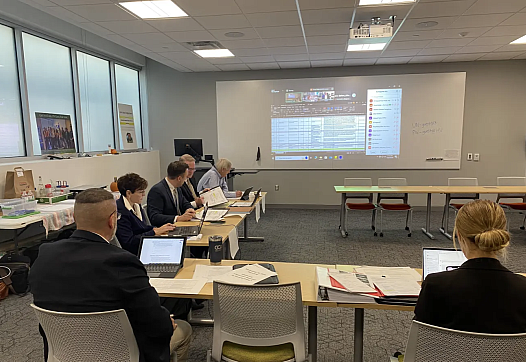 Room full of people looking at a presentation