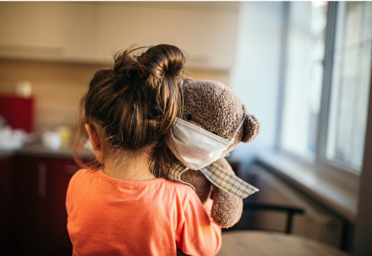 child holding a teddy bear